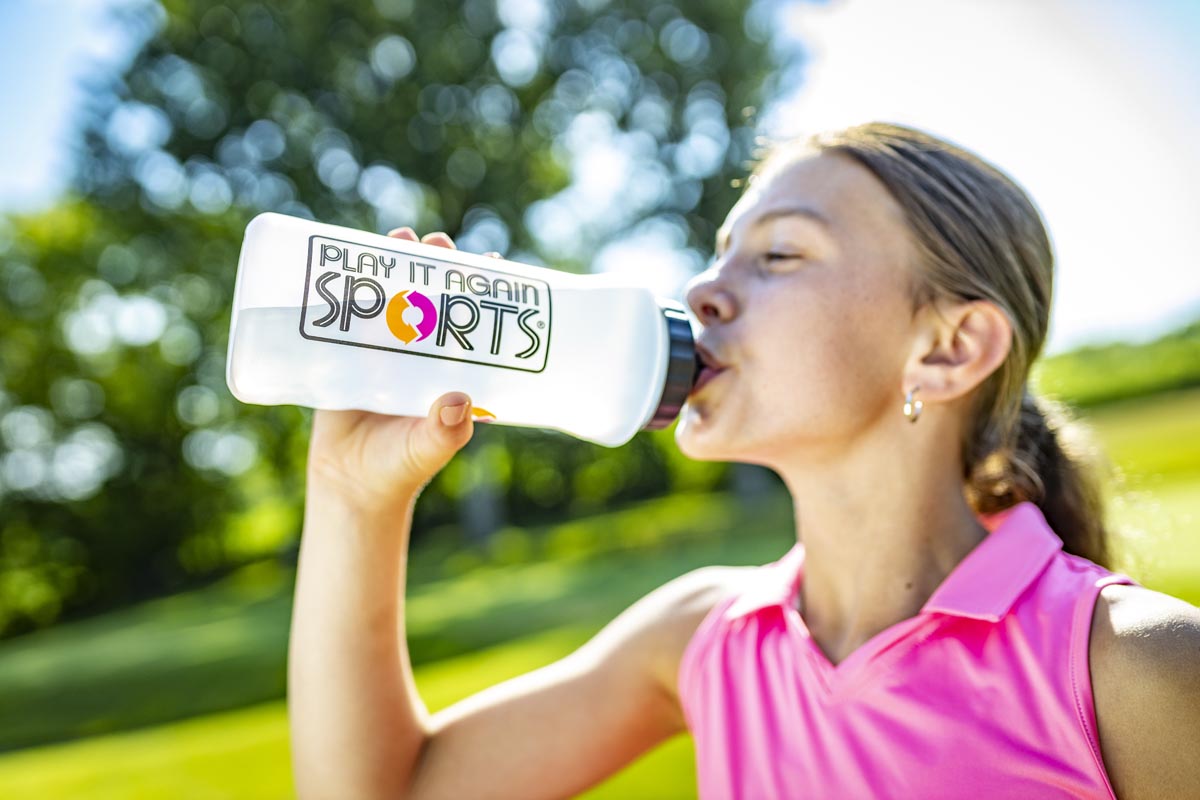 girl drinking out of water bottle
